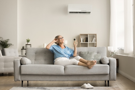 elderly woman enjoying the comfort of her ductless AC